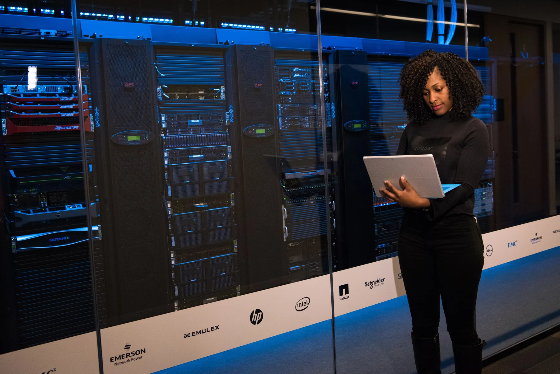 Engineer working beside server racks in a modern data center
